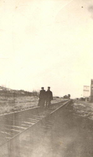 Frank and Anna Curtis, walking on railroad track in Choteau, Teton County, Montana, about 1916.